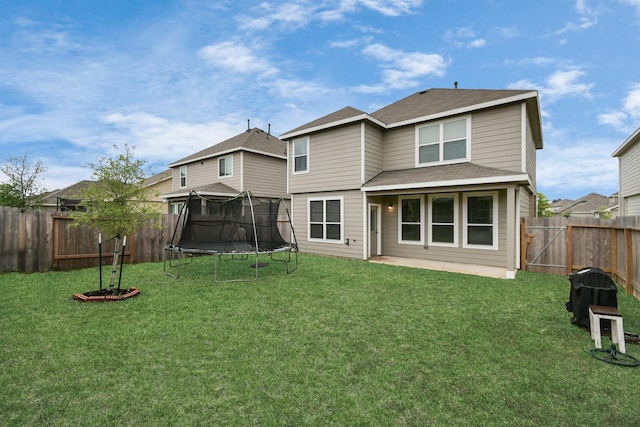 2832 Madison Dr, Conroe, TX 77304 - back of house with a trampoline, a fenced backyard, a patio, and roof with shingles
