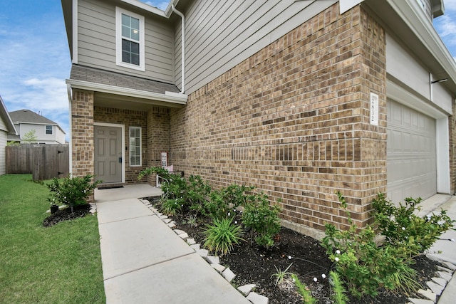 2832 Madison Dr, Conroe, TX 77304 - entrance to property featuring brick siding, a garage, and a shingled roof