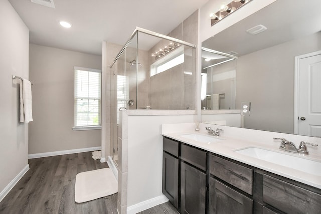 2832 Madison Dr, Conroe, TX 77304 - full bathroom featuring a stall shower, double vanity, and wood finished floors
