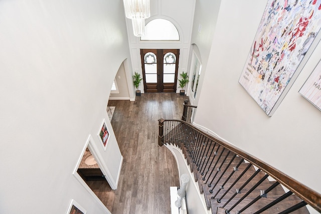 2510 Serene Path, Missouri City, TX 77459 - entrance foyer with arched walkways, a towering ceiling, wood finished floors, stairs, and a chandelier