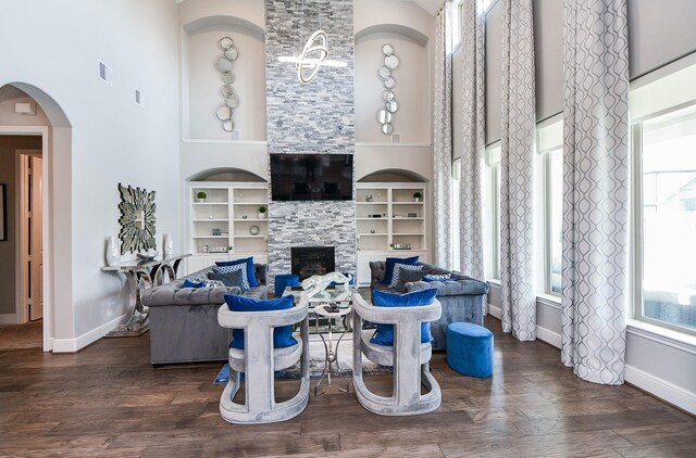 2510 Serene Path, Missouri City, TX 77459 - living room with built in shelves, a high ceiling, wood finished floors, and a large fireplace