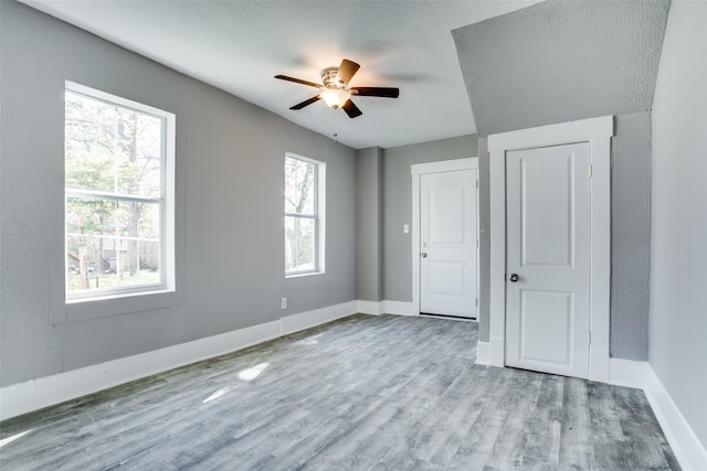 810-812 Maltby St Unit 6, Houston, TX 77011 - unfurnished bedroom with multiple windows, wood finished floors, and a ceiling fan