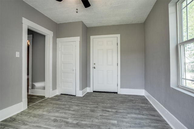 810-812 Maltby St Unit 6, Houston, TX 77011 - unfurnished bedroom featuring multiple windows, a textured ceiling, wood finished floors, and ceiling fan