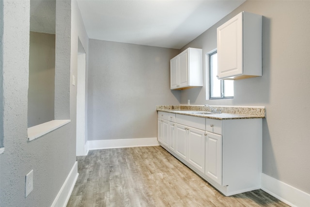 810-812 Maltby St Unit 6, Houston, TX 77011 - kitchen with light wood-style floors and white cabinets
