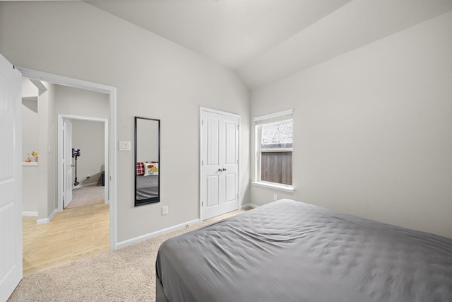 5442 Atwood Canyon Ct, Richmond, TX 77407 - bedroom with light carpet, lofted ceiling, and a closet