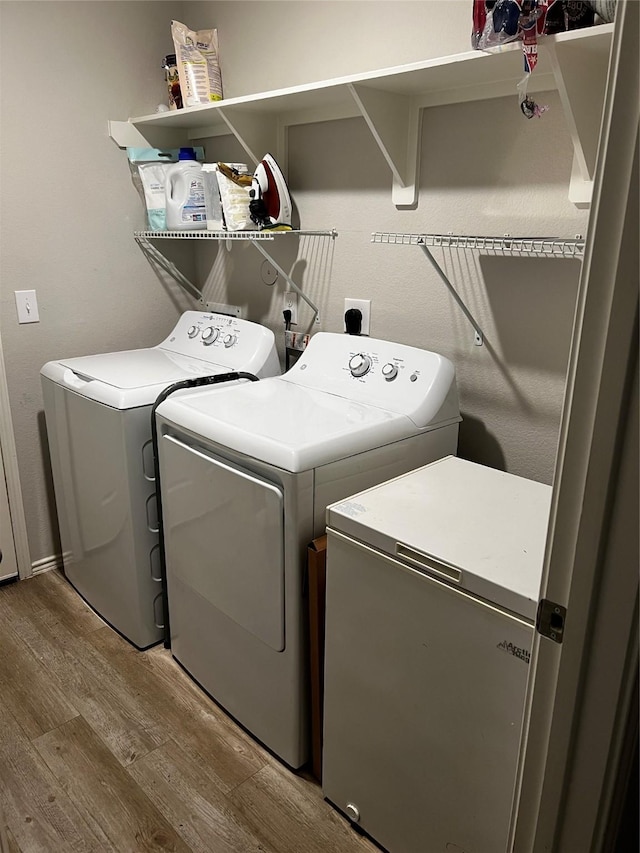 278 Cumberland Forest Dr, Magnolia, TX 77354 - laundry room with washer and dryer and wood finished floors