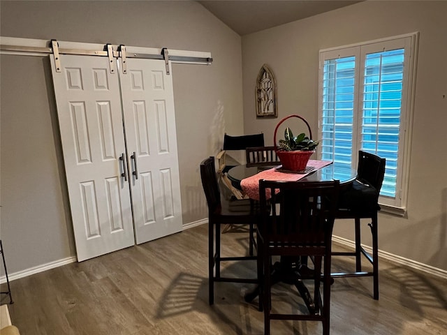 278 Cumberland Forest Dr, Magnolia, TX 77354 - dining space with a barn door, dark wood-style flooring, and vaulted ceiling