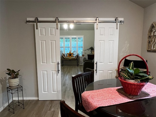 278 Cumberland Forest Dr, Magnolia, TX 77354 - dining area featuring a barn door and wood finished floors