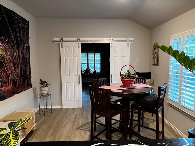 278 Cumberland Forest Dr, Magnolia, TX 77354 - dining area featuring wood finished floors, vaulted ceiling, and a barn door