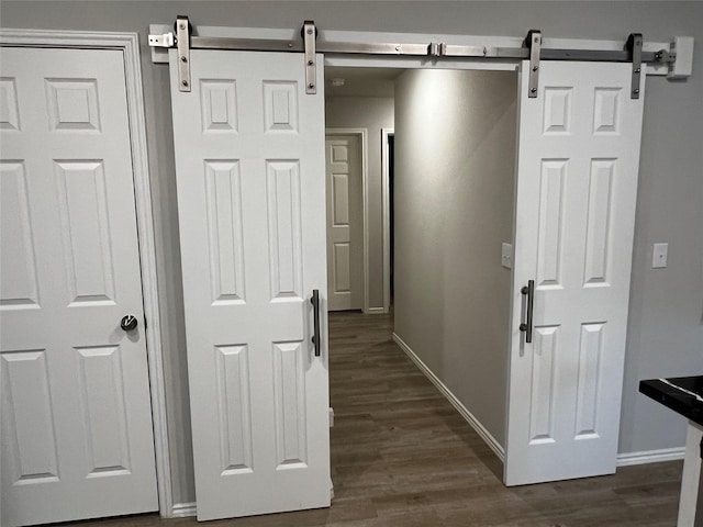 278 Cumberland Forest Dr, Magnolia, TX 77354 - hall featuring a barn door and dark wood-style flooring