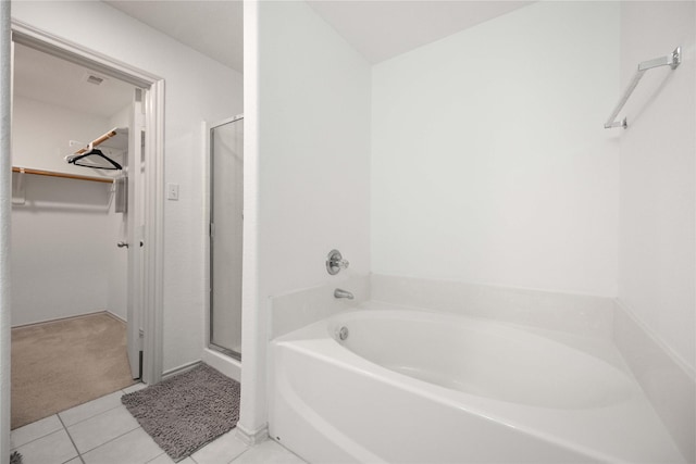 5767 Wandering Creek Dr, Richmond, TX 77469 - full bath featuring a walk in closet, a garden tub, a stall shower, and tile patterned flooring