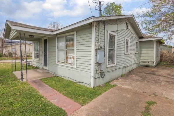 7973 Ritz St, Houston, TX 77028 - view of home's exterior featuring a lawn