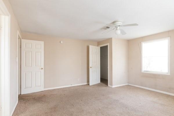 7973 Ritz St, Houston, TX 77028 - unfurnished bedroom featuring carpet, a closet, and a ceiling fan