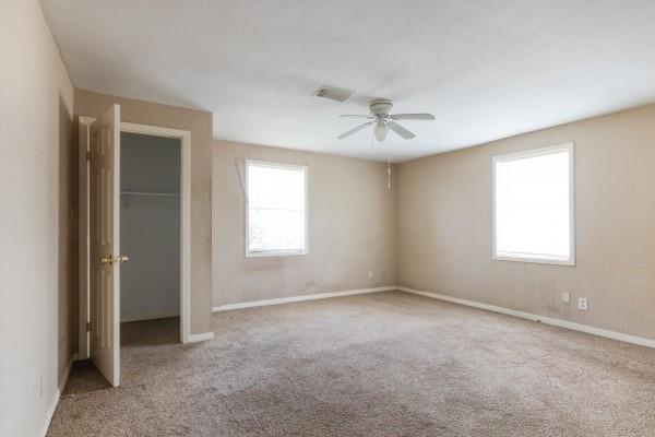7973 Ritz St, Houston, TX 77028 - unfurnished bedroom with carpet flooring, a closet, and a ceiling fan