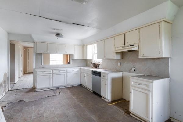 7973 Ritz St, Houston, TX 77028 - kitchen featuring under cabinet range hood, dishwasher, light countertops, and decorative backsplash