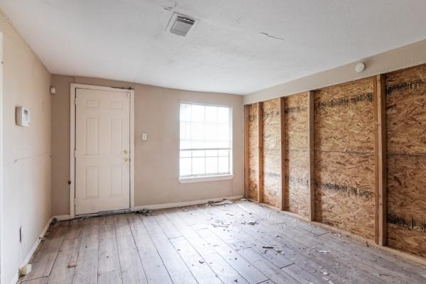 7973 Ritz St, Houston, TX 77028 - spare room with wood-type flooring and baseboards