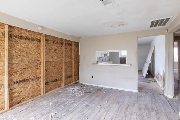7973 Ritz St, Houston, TX 77028 - unfurnished living room with hardwood / wood-style flooring