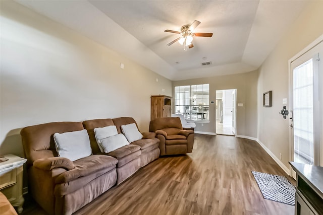 6402 Saint Jude Dr, Pasadena, TX 77505 - living room with a ceiling fan, healthy amount of natural light, wood finished floors, and a tray ceiling