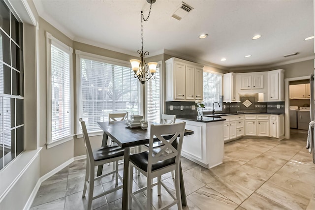 6402 Saint Jude Dr, Pasadena, TX 77505 - dining space featuring separate washer and dryer, crown molding, a chandelier, and recessed lighting