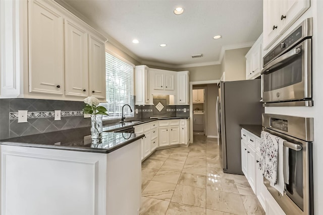 6402 Saint Jude Dr, Pasadena, TX 77505 - kitchen with stainless steel appliances, dark countertops, a peninsula, white cabinetry, and recessed lighting