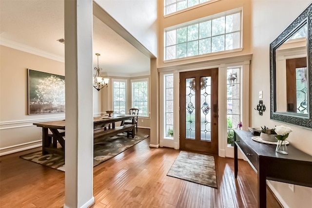 6402 Saint Jude Dr, Pasadena, TX 77505 - foyer entrance with a chandelier, wood finished floors, and crown molding