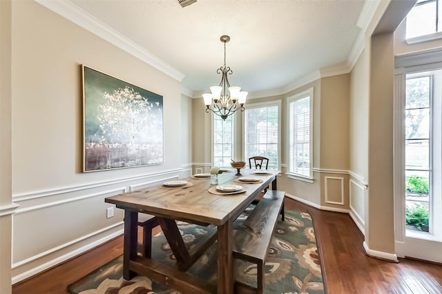 6402 Saint Jude Dr, Pasadena, TX 77505 - dining area featuring crown molding, a chandelier, dark wood finished floors, a wainscoted wall, and a decorative wall