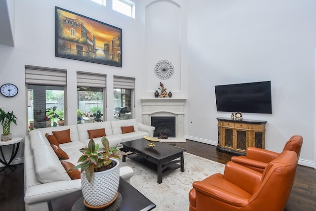 2710 Indigo Manor Ln, Katy, TX 77494 - living area featuring a high ceiling, wood finished floors, healthy amount of natural light, and a high end fireplace