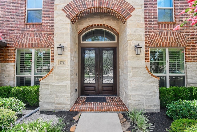2710 Indigo Manor Ln, Katy, TX 77494 - property entrance with french doors, stone siding, and brick siding
