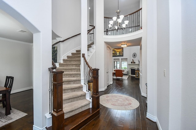 2710 Indigo Manor Ln, Katy, TX 77494 - foyer featuring hardwood / wood-style flooring, a chandelier, stairs, crown molding, and a towering ceiling