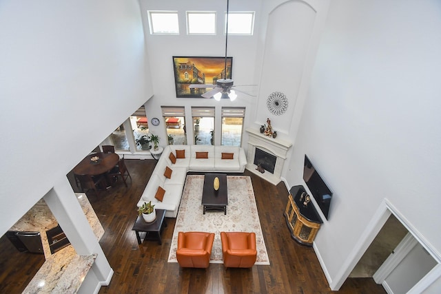 2710 Indigo Manor Ln, Katy, TX 77494 - living area with a towering ceiling, hardwood / wood-style flooring, a ceiling fan, and a fireplace with flush hearth
