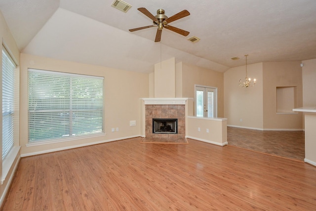 16902 Valley Palms Dr, Spring, TX 77379 - unfurnished living room with lofted ceiling, light wood-style floors, a fireplace, a ceiling fan, and a chandelier