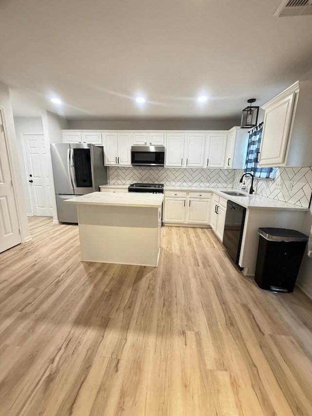 20918 Southhook Ct, Houston, TX 77073 - kitchen featuring black appliances, tasteful backsplash, a kitchen island, light countertops, and recessed lighting