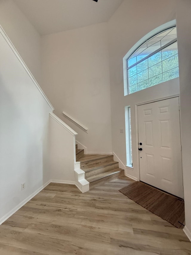 20918 Southhook Ct, Houston, TX 77073 - foyer entrance with stairway, light wood finished floors, and a towering ceiling