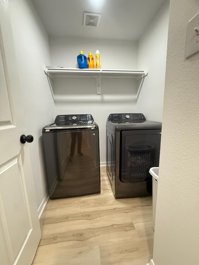 20918 Southhook Ct, Houston, TX 77073 - laundry area with washing machine and dryer and light wood finished floors