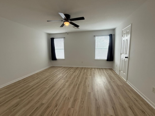 20918 Southhook Ct, Houston, TX 77073 - empty room with light wood-type flooring, healthy amount of natural light, and a ceiling fan