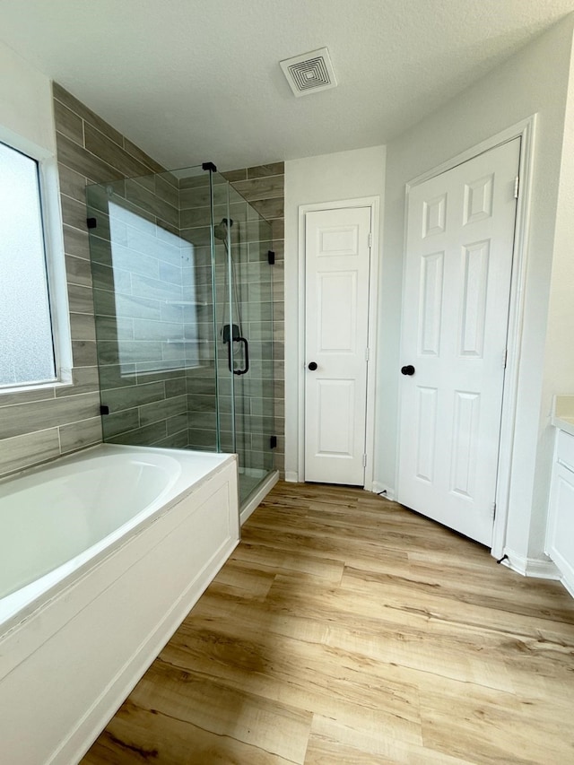 20918 Southhook Ct, Houston, TX 77073 - full bath featuring a bath, a shower stall, wood finished floors, and vanity