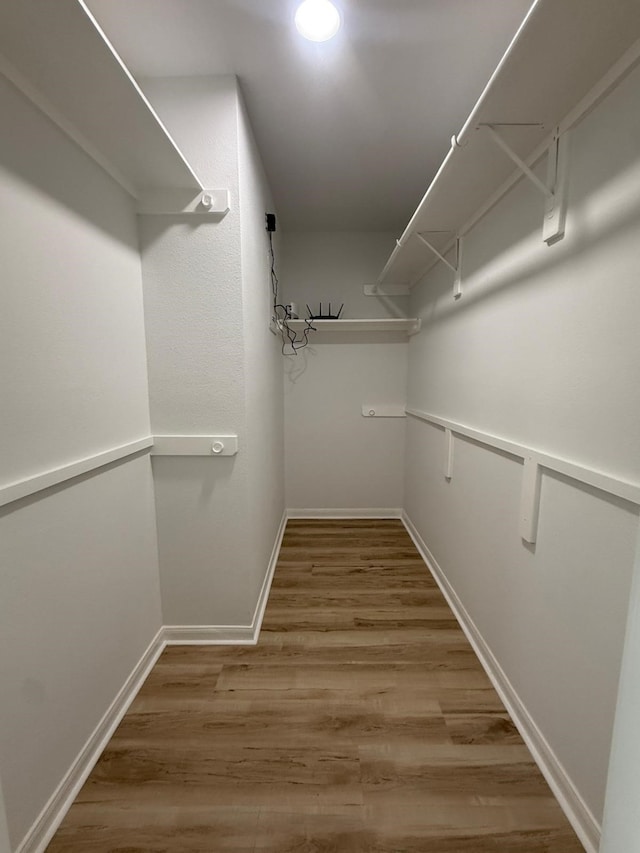 20918 Southhook Ct, Houston, TX 77073 - walk in closet featuring wood finished floors