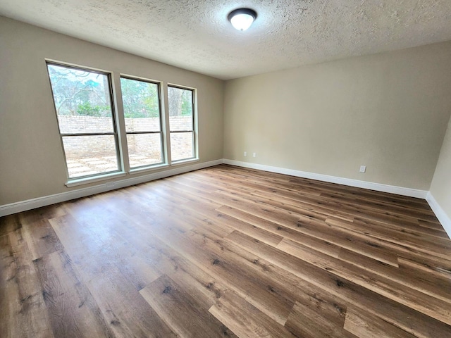 3407 Sandy Forks Dr, Houston, TX 77339 - empty room with dark wood-style flooring and a textured ceiling