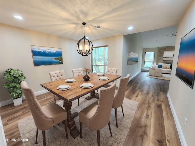 3407 Sandy Forks Dr, Houston, TX 77339 - dining area featuring wood finished floors, plenty of natural light, a chandelier, and recessed lighting