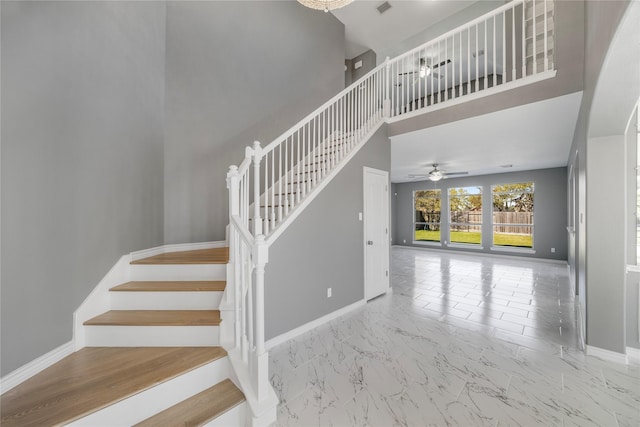 537 Green Cedar Dr, League City, TX 77573 - staircase featuring marble finish flooring, a ceiling fan, and a towering ceiling