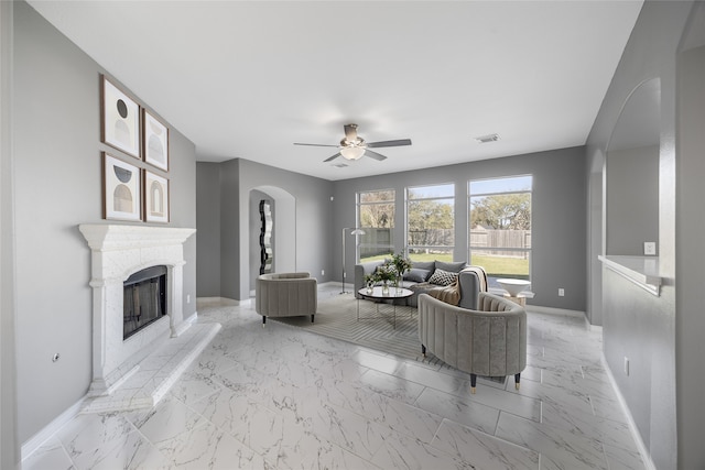 537 Green Cedar Dr, League City, TX 77573 - living room featuring arched walkways, ceiling fan, and light marble finish floors