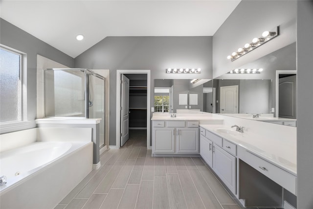 537 Green Cedar Dr, League City, TX 77573 - bathroom with a shower stall, vanity, a bath, lofted ceiling, and a spacious closet