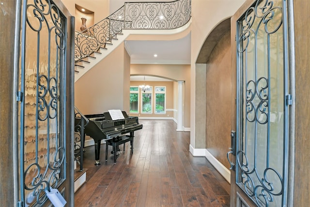 13622 Kluge Corner Ln, Cypress, TX 77429 - entrance foyer featuring arched walkways, ornamental molding, dark wood-type flooring, a chandelier, and stairs