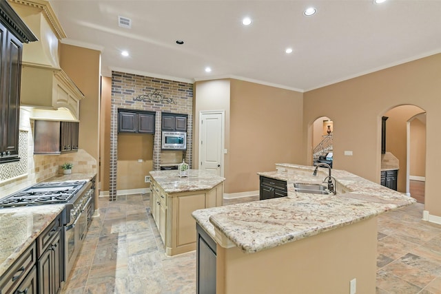 13622 Kluge Corner Ln, Cypress, TX 77429 - kitchen featuring a spacious island, arched walkways, stainless steel appliances, recessed lighting, and crown molding