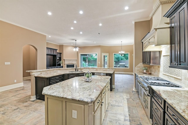 13622 Kluge Corner Ln, Cypress, TX 77429 - kitchen with a spacious island, range with two ovens, crown molding, recessed lighting, and backsplash