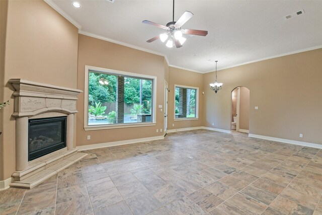 13622 Kluge Corner Ln, Cypress, TX 77429 - unfurnished living room featuring a ceiling fan, a glass covered fireplace, arched walkways, ornamental molding, and stone finish floors