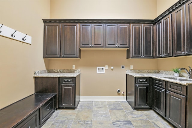 13622 Kluge Corner Ln, Cypress, TX 77429 - laundry area with hookup for a gas dryer, cabinet space, hookup for a washing machine, hookup for an electric dryer, and light stone finish floors