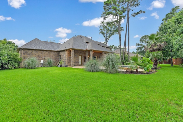 13622 Kluge Corner Ln, Cypress, TX 77429 - rear view of property featuring a lawn, a shingled roof, and brick siding
