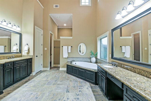 13622 Kluge Corner Ln, Cypress, TX 77429 - full bath featuring a towering ceiling, two vanities, a bath, and crown molding