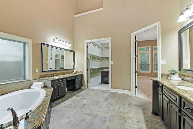 13622 Kluge Corner Ln, Cypress, TX 77429 - full bath with two vanities, a bath, a high ceiling, and a walk in closet